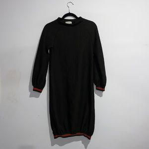 Black dress with popping patterns. Red & black stripes around wrists & on bottom